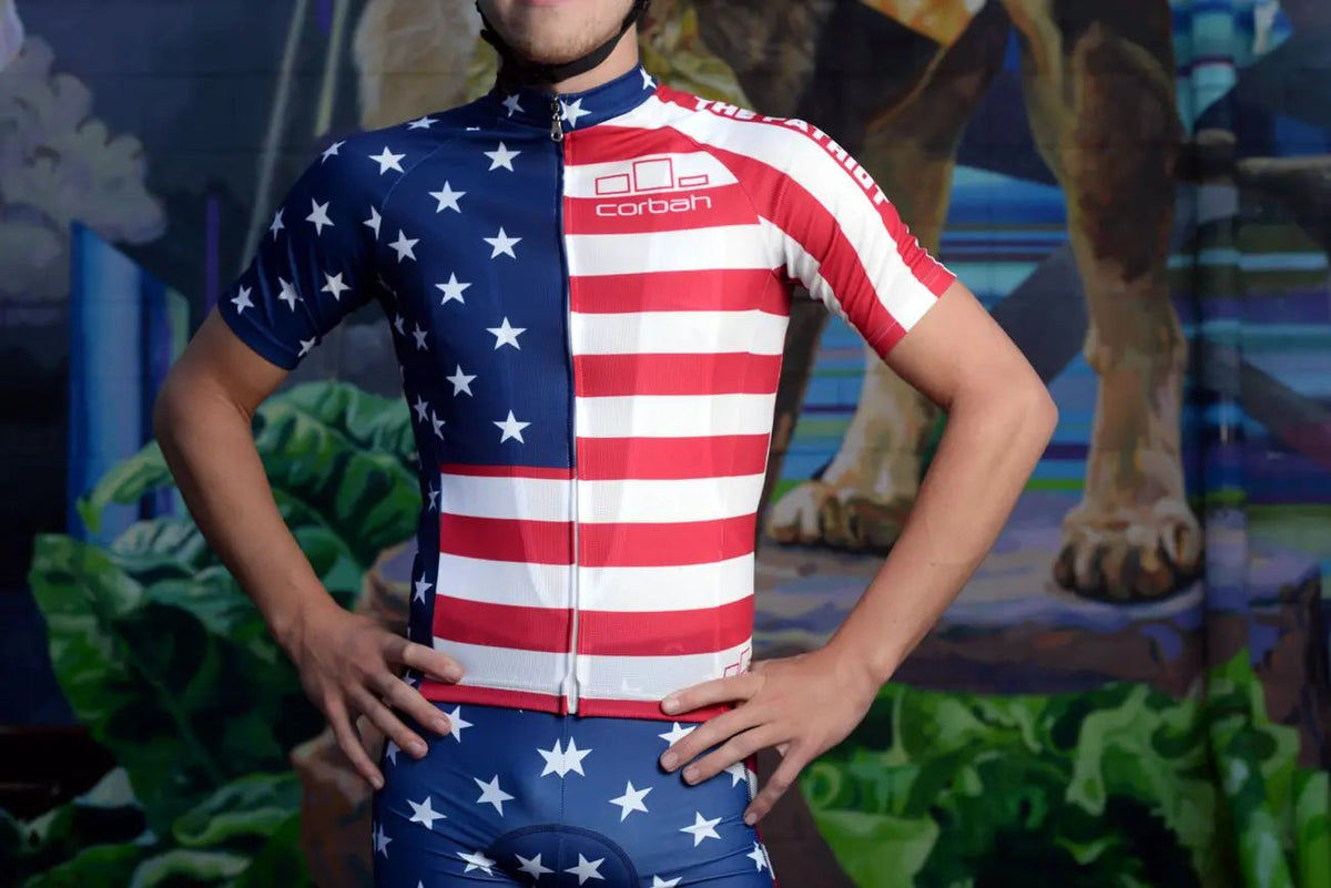 Rider wearing The Patriot American flag cycling jersey, front view with hands on hips