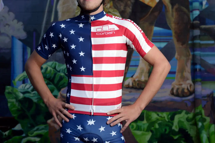 Rider wearing The Patriot American flag cycling jersey, front view with hands on hips