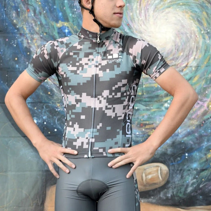 Rider in the Weekend Warrior camo jersey in front of a painted mural