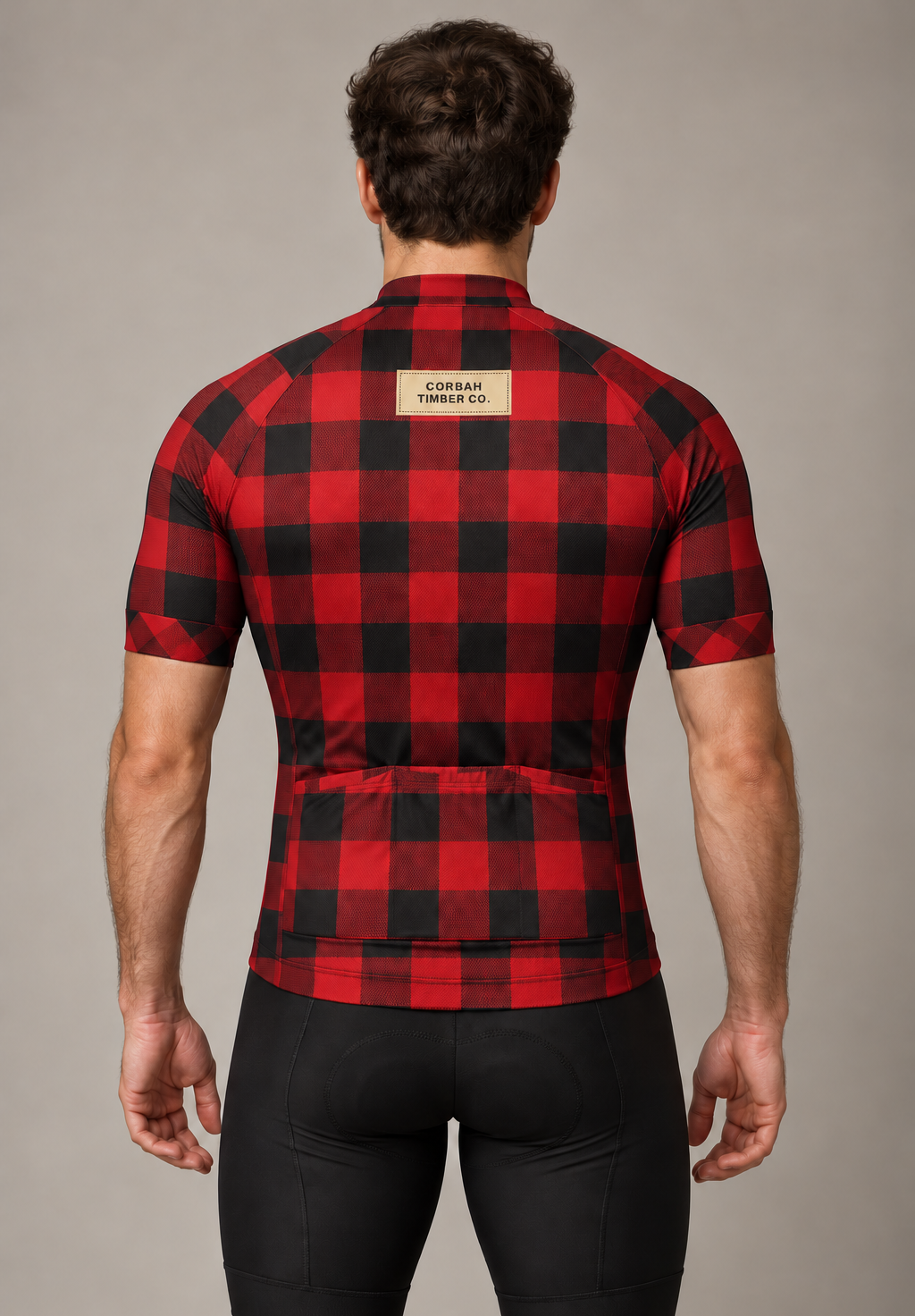 Back of The Lumberjack jersey on a rider: buffalo check, CORBAH TIMBER CO. label and three rear pockets. Bib shorts sold separately.