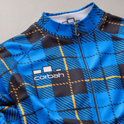 Close-up of the Scotsman jersey chest: white Corbah logo, front zip, collar and hatched blue, black and gold plaid fabric