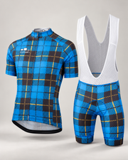 Corbah Scotsman plaid cycling jersey shown with the matching bib shorts (bib shorts sold separately) in a studio: electric blue with black plaid blocks and thin gold lines