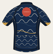 Back of the Corbah Koi Rising Current cycling jersey with the vermillion sun and Corbah mark over indigo waves.