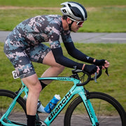 Racer in the Weekend Warrior camo racesuit on a road race course.